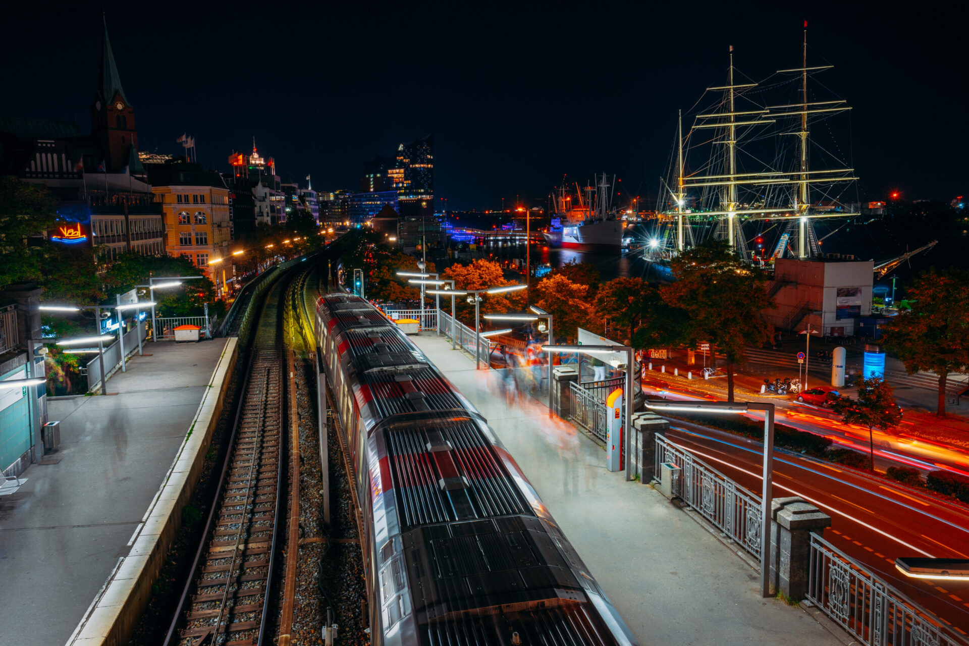 Landungsbruecken in Hamburg during night. Panorama of Harbor and metro station, Germany. Light trails Long exposure Hamburg Sternschanze